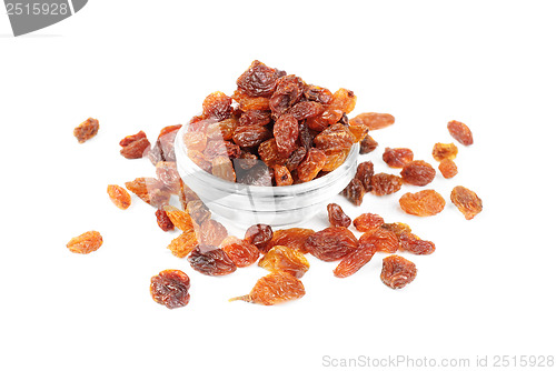 Image of raisins close- up in glass bowl isolated on white background 