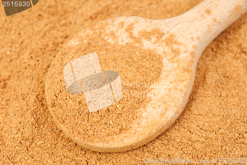 Image of Cinnamon  powder and wooden spoon as  nature  food   background