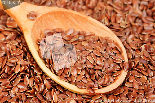 Image of close up of flax seeds and wooden spoon food background