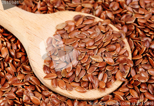 Image of close up of flax seeds and  wooden spoon food background