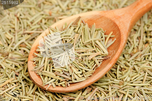 Image of rosemary in wooden spoon and over as background 