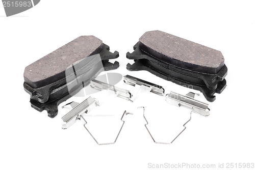 Image of four brake pads and spring, isolatet on white 