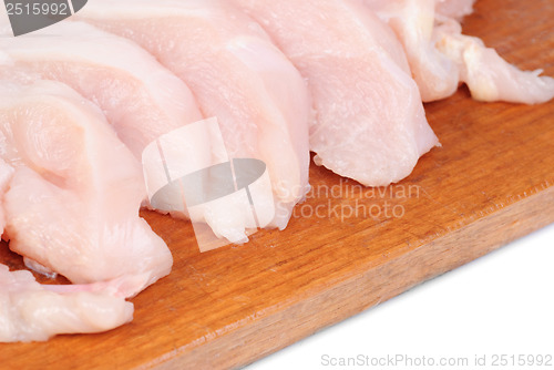 Image of chicken meat sliced   on  cutting  board isolated  on  white  background