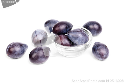Image of Some fresh blue plums on the white background