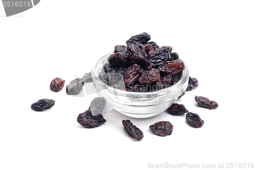 Image of dark  raisins close- up in glass bowl isolated  on  white background