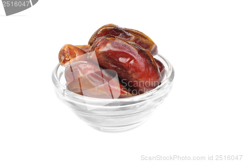 Image of dried dates on glass bowl isolated on white background