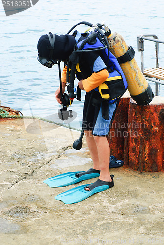 Image of Little scuba diver , before diving into sea 