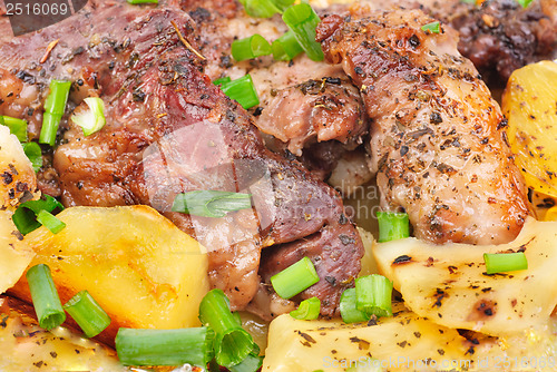Image of Barbecue meat with potato close-up as food background 