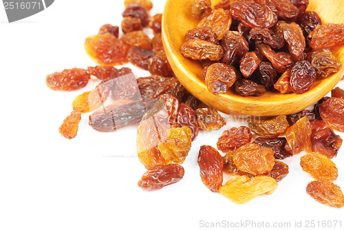 Image of raisins and  wooden  spoon close- up  isolated on  white background 