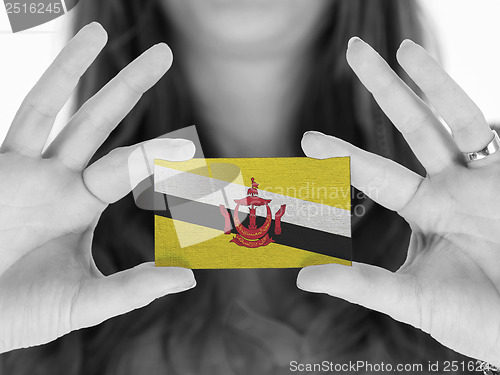 Image of Woman showing a business card