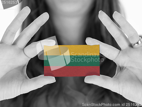 Image of Woman showing a business card