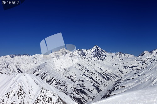 Image of View on off-piste slope, winter snowy mountains and blue clear s