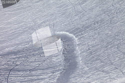 Image of Off-piste slope and snowy road with trace from ski and snowboard