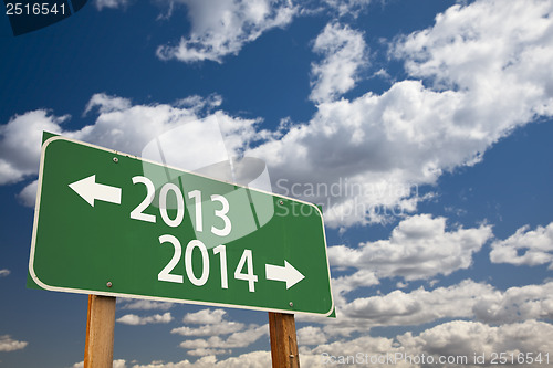 Image of 2013, 2014 Green Road Sign Over Clouds