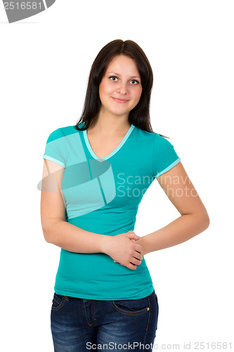 Image of young woman in green t-shirt and blue jeans posing over white