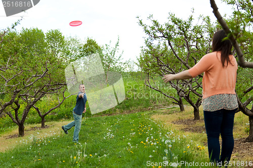 Image of Couple Playing Frisbee Together