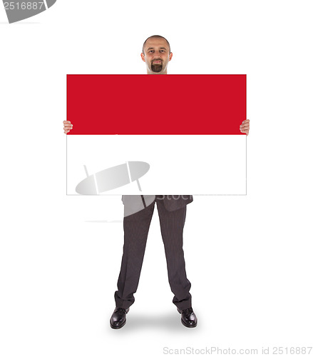 Image of Smiling businessman holding a big card or flag