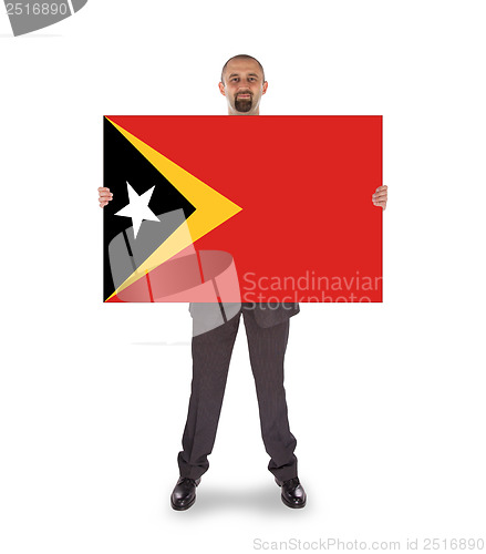 Image of Smiling businessman holding a big card or flag