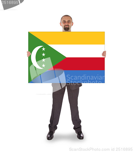 Image of Smiling businessman holding a big card or flag