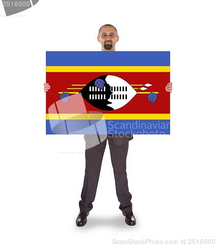 Image of Smiling businessman holding a big card or flag