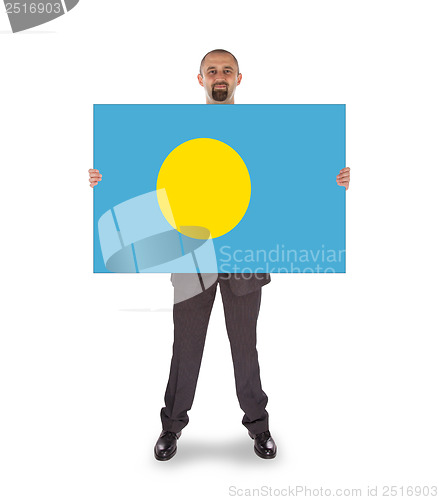 Image of Smiling businessman holding a big card or flag