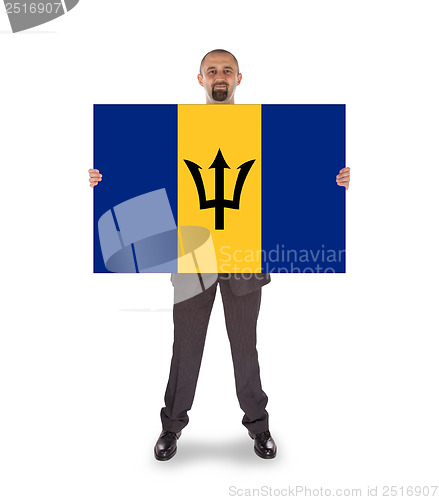 Image of Smiling businessman holding a big card or flag