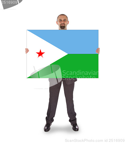 Image of Smiling businessman holding a big card or flag