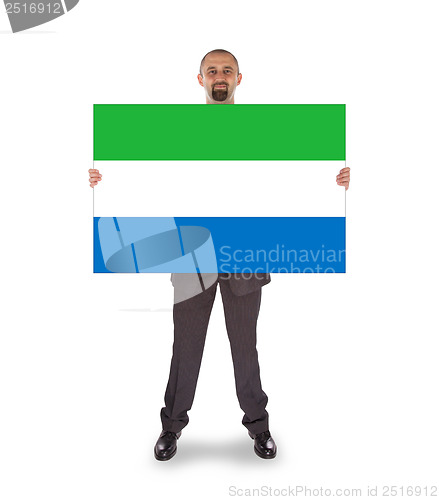 Image of Smiling businessman holding a big card or flag