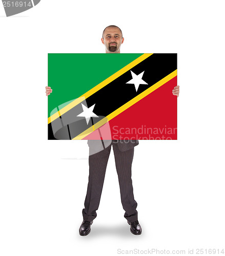 Image of Smiling businessman holding a big card or flag