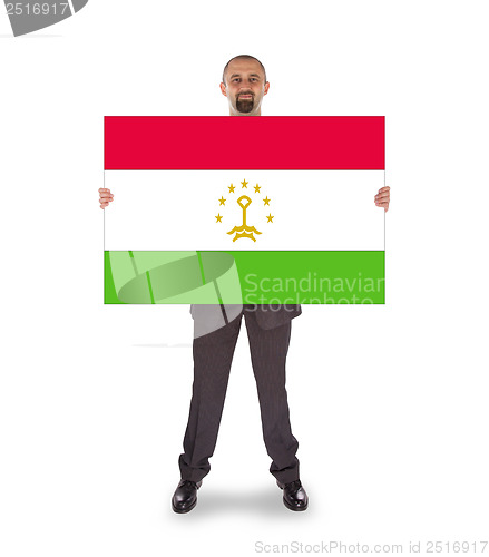 Image of Smiling businessman holding a big card or flag