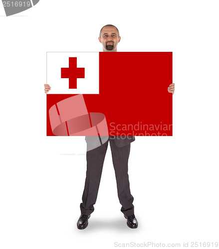 Image of Smiling businessman holding a big card or flag