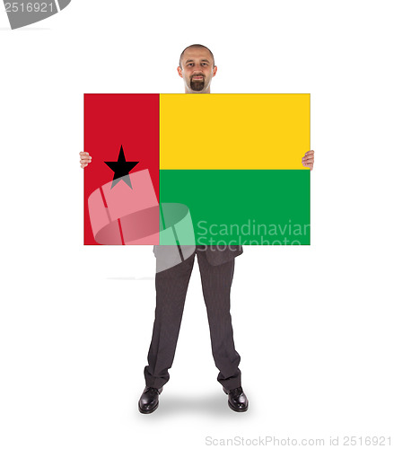 Image of Smiling businessman holding a big card or flag