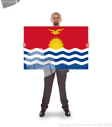 Image of Smiling businessman holding a big card or flag