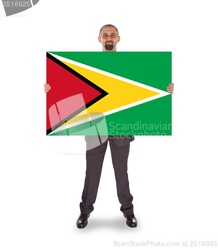 Image of Smiling businessman holding a big card or flag