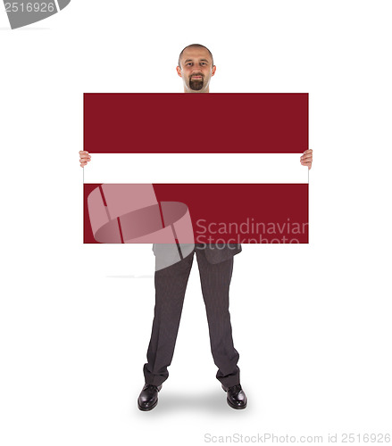 Image of Smiling businessman holding a big card or flag