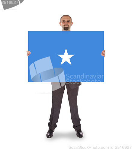 Image of Smiling businessman holding a big card or flag