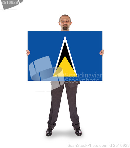 Image of Smiling businessman holding a big card or flag