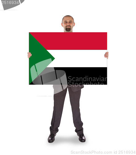 Image of Smiling businessman holding a big card or flag