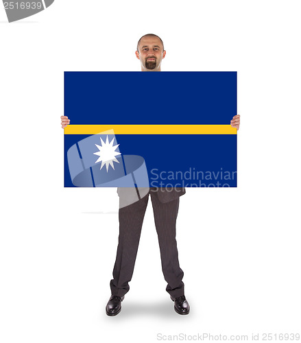 Image of Smiling businessman holding a big card or flag