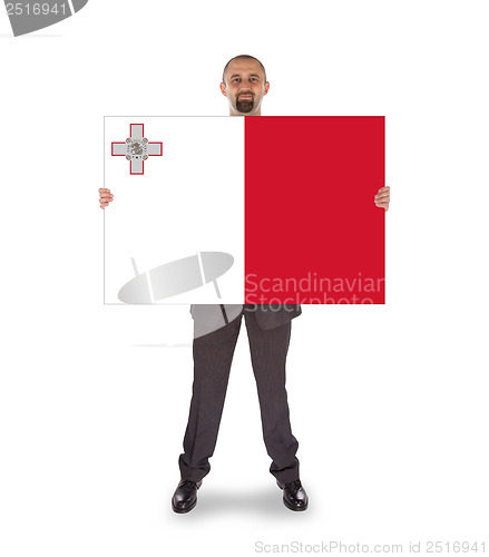 Image of Smiling businessman holding a big card or flag