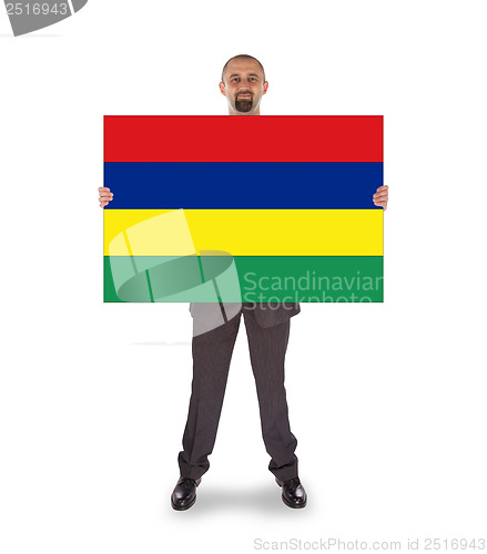 Image of Smiling businessman holding a big card or flag