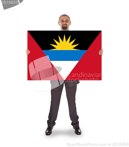 Image of Smiling businessman holding a big card or flag