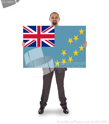 Image of Smiling businessman holding a big card or flag