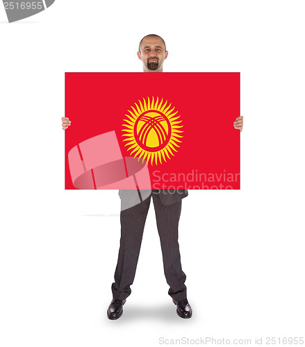 Image of Smiling businessman holding a big card or flag