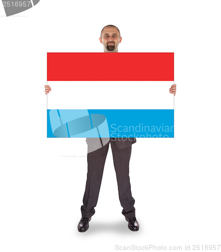 Image of Smiling businessman holding a big card or flag