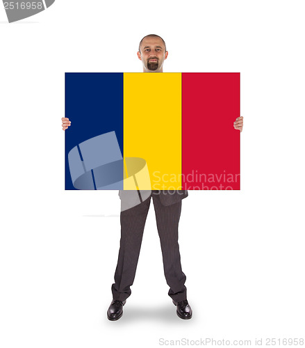 Image of Smiling businessman holding a big card or flag