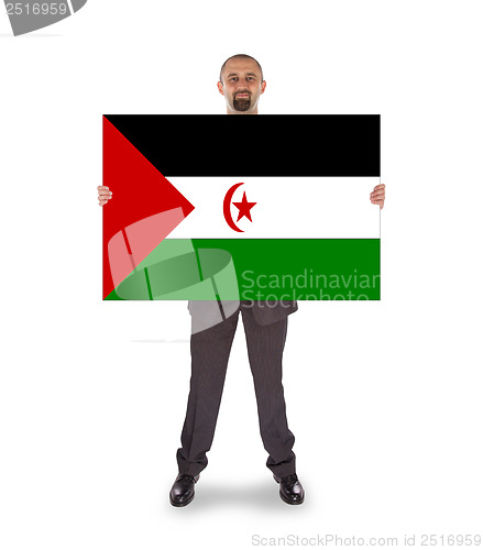 Image of Smiling businessman holding a big card or flag