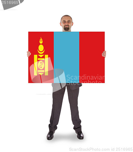 Image of Smiling businessman holding a big card or flag