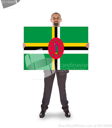 Image of Smiling businessman holding a big card or flag