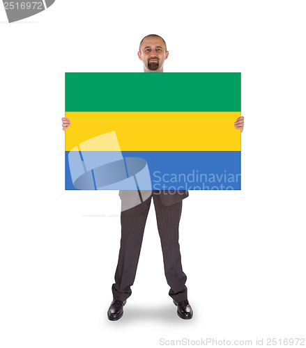 Image of Smiling businessman holding a big card or flag